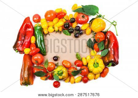 Assorted tomatoes and vegetables isolated on white background. Photo for your design