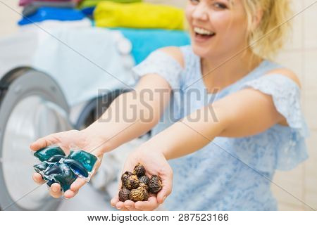 Woman Comparing Washing Laundry Nuts And Chemicals Detergent Blue Pods. Alternative Household Duties