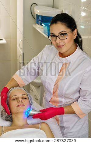 Girl In Spa Salon. Cosmetic Procedure For Rejuvenation. Ultrasonic Cleaning And Face Lift. Cosmetolo