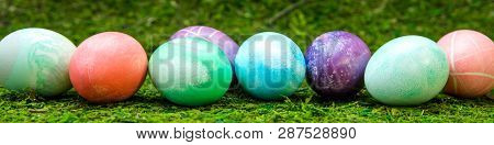 Panorama, Colorful Dyed Easter Eggs In A Line On Green Meadow Or Moss