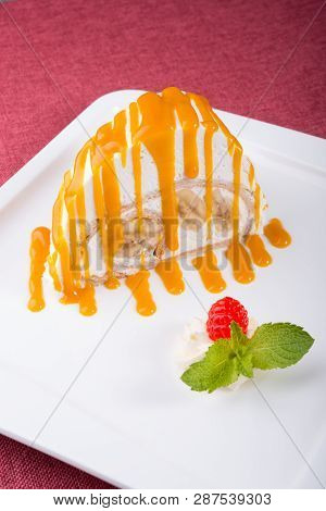 White Spoonge Peice Of Cake With Yellow Syrup