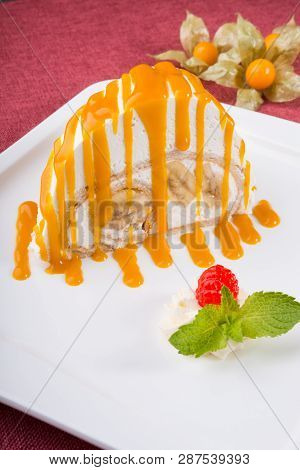 White Spoonge Peice Of Cake With Yellow Syrup