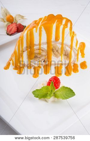 White Spoonge Peice Of Cake With Yellow Syrup