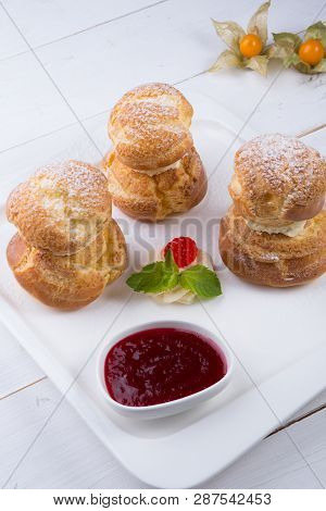 Baked French Desserts Suffed With Cream And Served With Jam