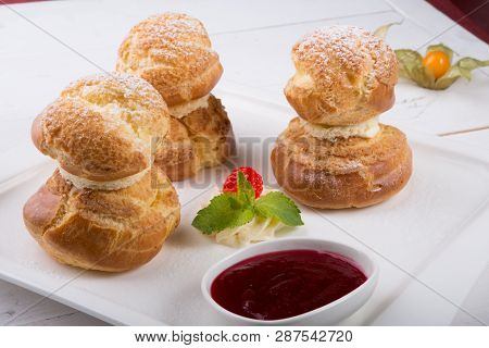 Baked French Desserts Suffed With Cream And Served With Jam