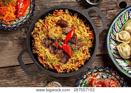 Traditional Uzbek Oriental Cuisine. Uzbek Family Table From Different Dishes In National Dishes For