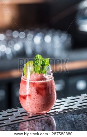Cocktail Drink Frozen Strawberry Daiquiri At Barcounter In Night Club Or Restaurant.