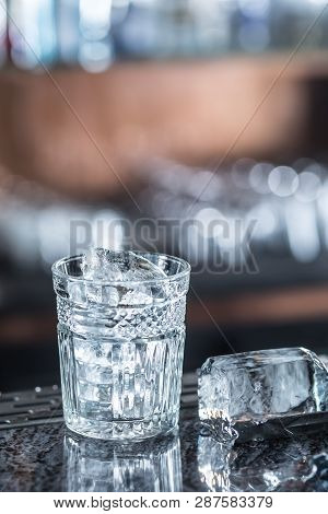 Ice Cubes In Glass At Barcounter In Night Club Or Restaurant.