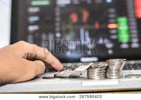 Hand Using Laptop Silver Coin With Monitor Shows Trading Traffic, Bitcoin Mining, Coin Colapse In Fr