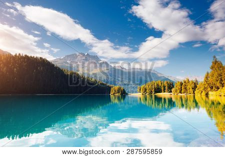 Exotic alpine lake Champfer in beautiful summer day. Location place Silvaplana village, Swiss alps, district Maloja, Europe. Scenic image of popular tourist destination. Discover the beauty of earth.