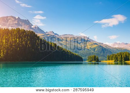 Alpine lake Champfer in beautiful summer day. Location place Silvaplana village, Swiss alps, district Maloja, Europe. Scenic image of most popular vacation destinations. Discover the beauty of earth.