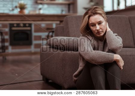 Woman Wearing Brown Squared Trousers Feeling Depressed