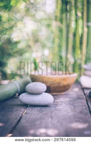 Spa Background With Woman's Hands And Clear Water On An Old Wooden Table. Japanese Style. Simplicity