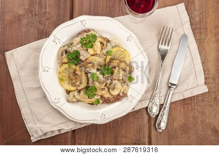A Closeup Of Scallopine Di Vitello, Veal Scallopini, With A Mushroom Sauce, Lemons, And Parsley, Sho
