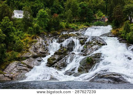 Hellesylt Fossen waterfall in the area Geirangerfjord in village Hellesylt
