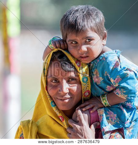 Ranthambore, India - February 4, 2011: Portrait Of A Rajasthani Mother With Kid In Ranthambore. Raja
