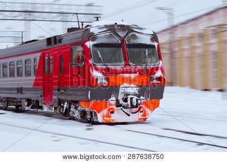 Ice-covered Electric Multiple Unit Train Rushes Along A Blurred Winter Railway Landscape