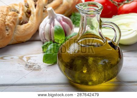 Virgin Natural Olive Oil Is Glass Bottle, Served With Traditional Mediterranean Food