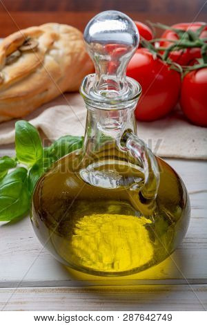 Virgin Natural Olive Oil Is Glass Bottle, Served With Traditional Mediterranean Food