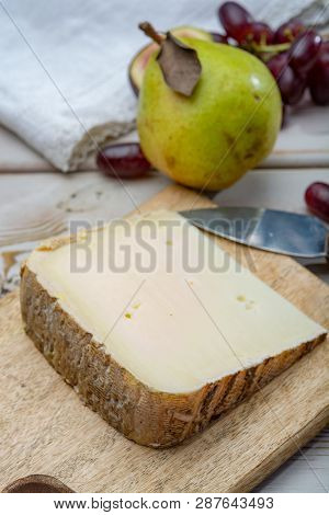 Piece Of French Cheese Tomme De Brebis Made From Sheep Milk Served As Dessert With Fresh Figs And Pe