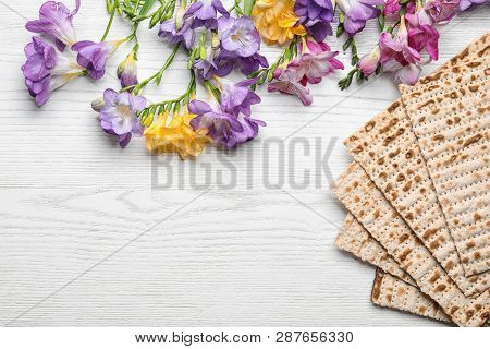 Flat Lay Composition Of Matzo And Flowers On Wooden Background, Space For Text. Passover (pesach) Se