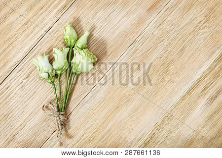 Small Delicate Flowers Of Eustoma On A Wooden Surface. Small Bouquet On Aged Wood Table.