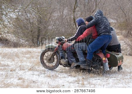 A Team On A Soviet Retro Motorcycle With A Sidecar In The Mud And Snow Riding Cross-country