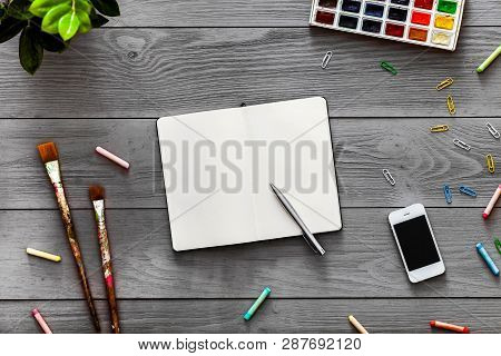 Colorful Creative Artist Table With Blank Notebook For Work Sketches And Paints, Art Paintbrushes Su