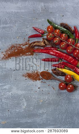 Fresh And Dried Tomatoes And Hot Chili Peppers With A Spoon Of Cayenne Pepper