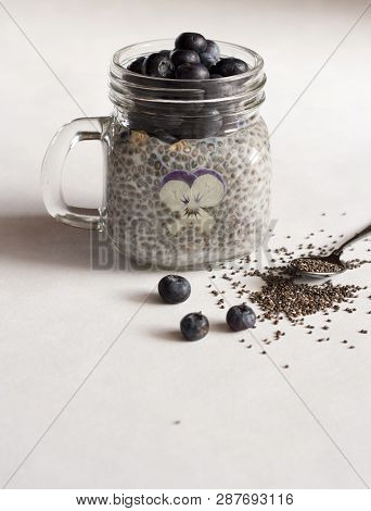Chia Pudding With Flower And Blueberry And Spoon Seeds