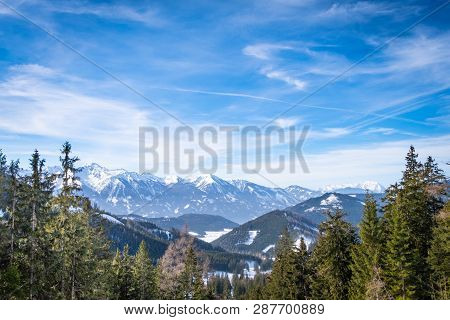 Panoramic View Thruogh Forest On Snowy Plateau Kaiserau To Mountains Rottenmanner Tauern And Dachste