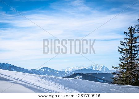 Panoramic View From Snowy Plateau Kaiserau To Mountains Rottenmanner Tauern And Dachstein On A Sunny