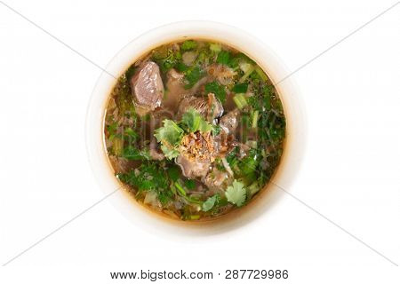 Asian bone soup or sup tulang, popular traditional malay dish. Top view flat lay isolated on white background .