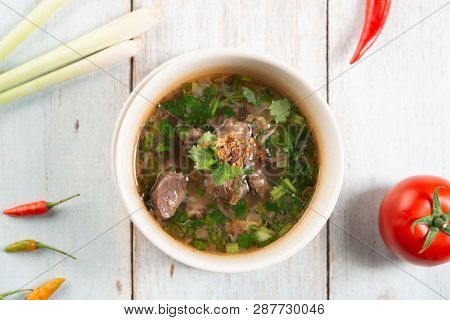 Asian bone soup or sup tulang, popular traditional malay dish. Top view flat lay.
