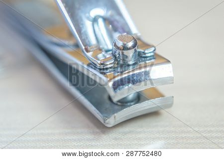 Close Up Of A Nail Cutter Nail Trimmer Nail Shaper Kept On A Wooden Table. Copy Space Provided