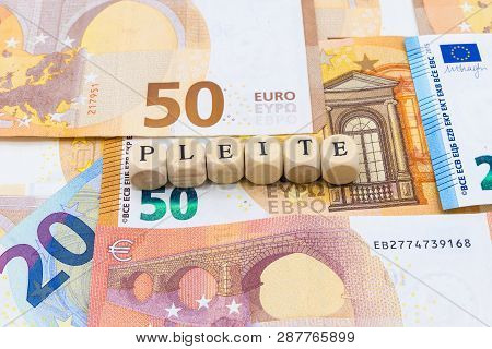 Wooden Letters On Banknotes Bankrupt German 