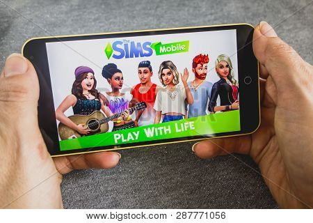Berdyansk, Ukraine - March 4, 2019 - Close Up Of Hand Of Person Playing The Sims Mobile Game Apllica