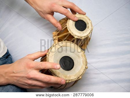 A Man Plays The Ethnic Drum. Close-up.