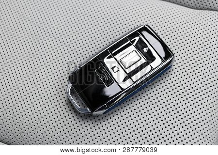 Closeup Inside Vehicle Of Wireless Blue Leather Key Ignition On White Leather Seat. Wireless Start E