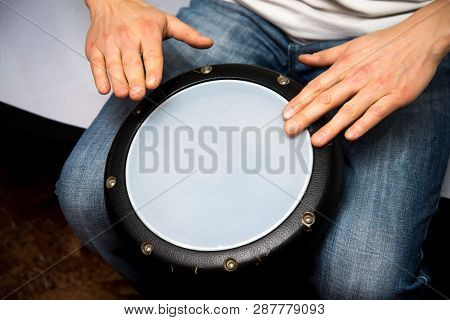 A Man Plays The Ethnic Drum. Close-up.