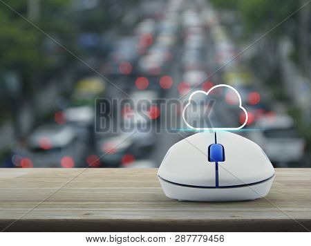 Cloud Flat Icon With Copy Space And Wireless Computer Mouse On Wooden Table Over Blur Of Rush Hour W