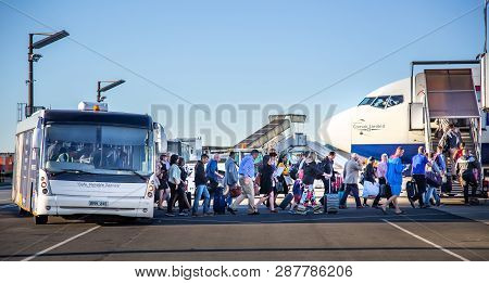Johannesburg, South Africa, 28th February - 2019: Passengers Getting Out Of Airport Bus And Into Air
