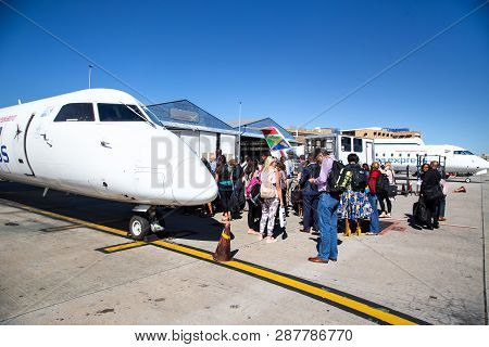 Johannesburg, South Africa, 28th February - 2019: Passengers Waiting To Board A Plane On The Tarmac.