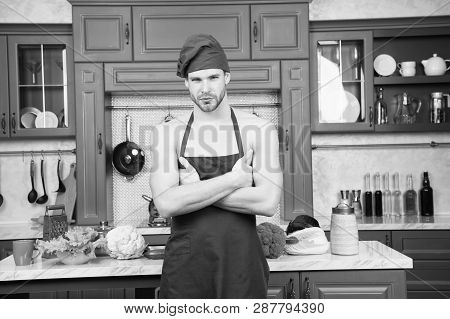 Man Attractive Nude Chef Wear Apron And Hat. Sexy Muscular Chef In Front Of Kitchen. Attractive Chef