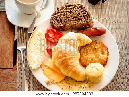 Breakfast At Cafe With Croissant, Bread, Cheese, Tomatoes On Plate.