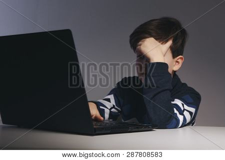 Closeup Picture Of Bullying Teen Boy Feeling Upset Infront Of Computer. Stressed Sad Boy Is Bullying