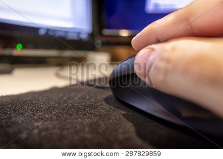 Hand Over Computer Mouse On A Mouse Pad