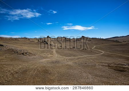 Wide Steppe With Yellow Grass Under A Blue Sky With White Clouds Tazheran Steppe, Siberia Russia