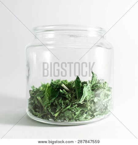 Dry Melissa And Mint Tea In The Jar Isolated On White Background. Homemade And Healthy