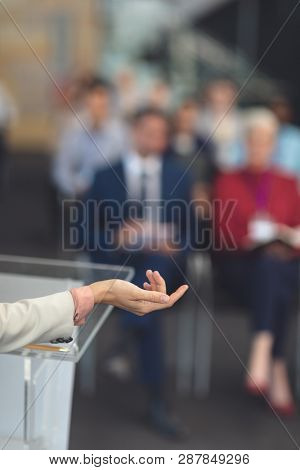 Close-up of mixed race female speaker hand while shes speaking at a business seminar in office
